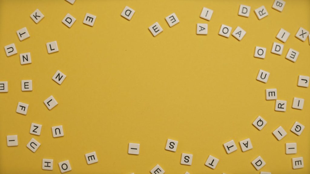 Scattered Letters on Yellow Surface