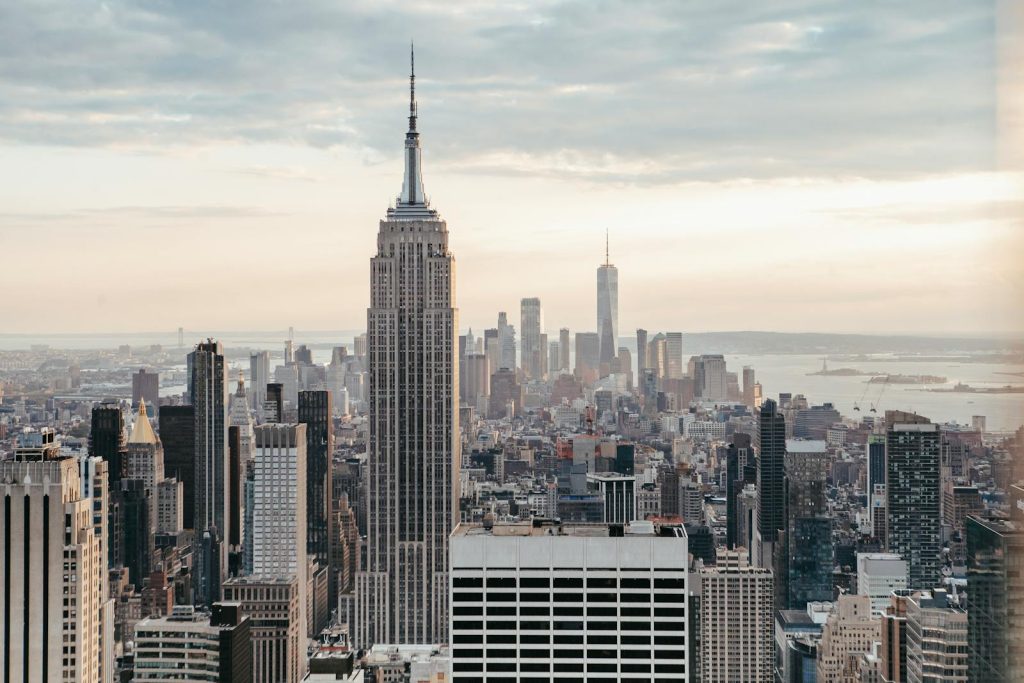 Empire State Building near multistage houses against ocean